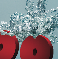 L'image montre des cercles rouges qui semblent plonger dans l'eau, provoquant des éclaboussures autour d'eux. Les bulles et les gouttes d'eau sont bien visibles, créant un effet dynamique et vivant. Le fond est en eau, ce qui accentue le mouvement de l'éclaboussure.