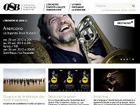 L'image semble être une capture d'écran d'un site web dédié à l'Orchestre Symphonique de Bretagne (OSB). En haut, il y a un titre mentionnant "L'orchestre se lâche #1" avec une référence à un concert appelé "Americana" célébrant la légende Dave Brubeck. Des informations sur les dates des concerts, à savoir le 24 et le 25 octobre 2012, ainsi que les lieux de présentation, sont également affichées. En bas, il y a des sections pour l'ouverture de la billetterie, des informations sur la saison et un artiste invité nommé Darrell Ang. L'ensemble de la présentation est à la fois attirant et informatif, évoquant l'ambiance d'un événement musical.